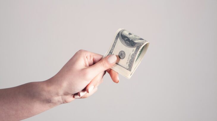 person holding 1 us dollar bill