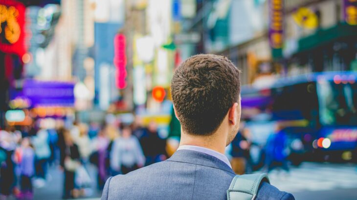 shallow focus photography of man in suit jacket's back